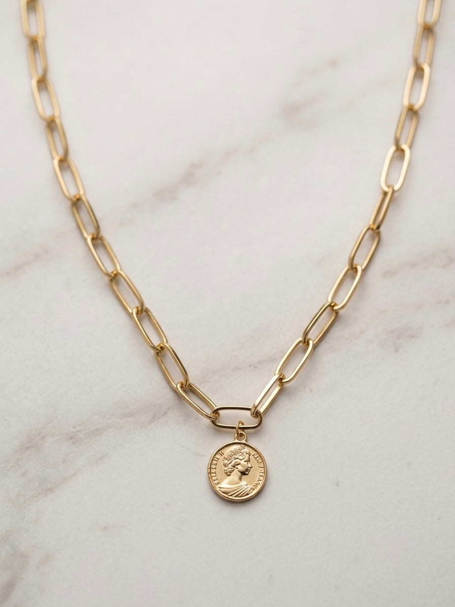 EMIN. branded gold paperclip chain necklace on marble surface