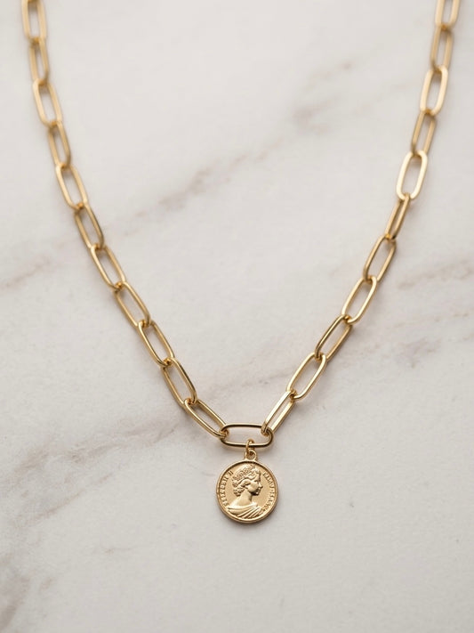 EMIN. branded gold paperclip chain necklace on marble surface