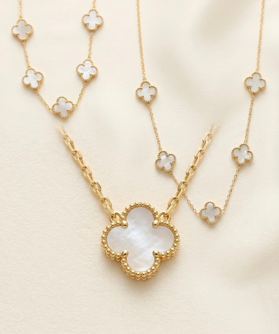 EMIN. White Mother of Pearl Clover Set – necklace, bracelet, ring and earrings flat lay
