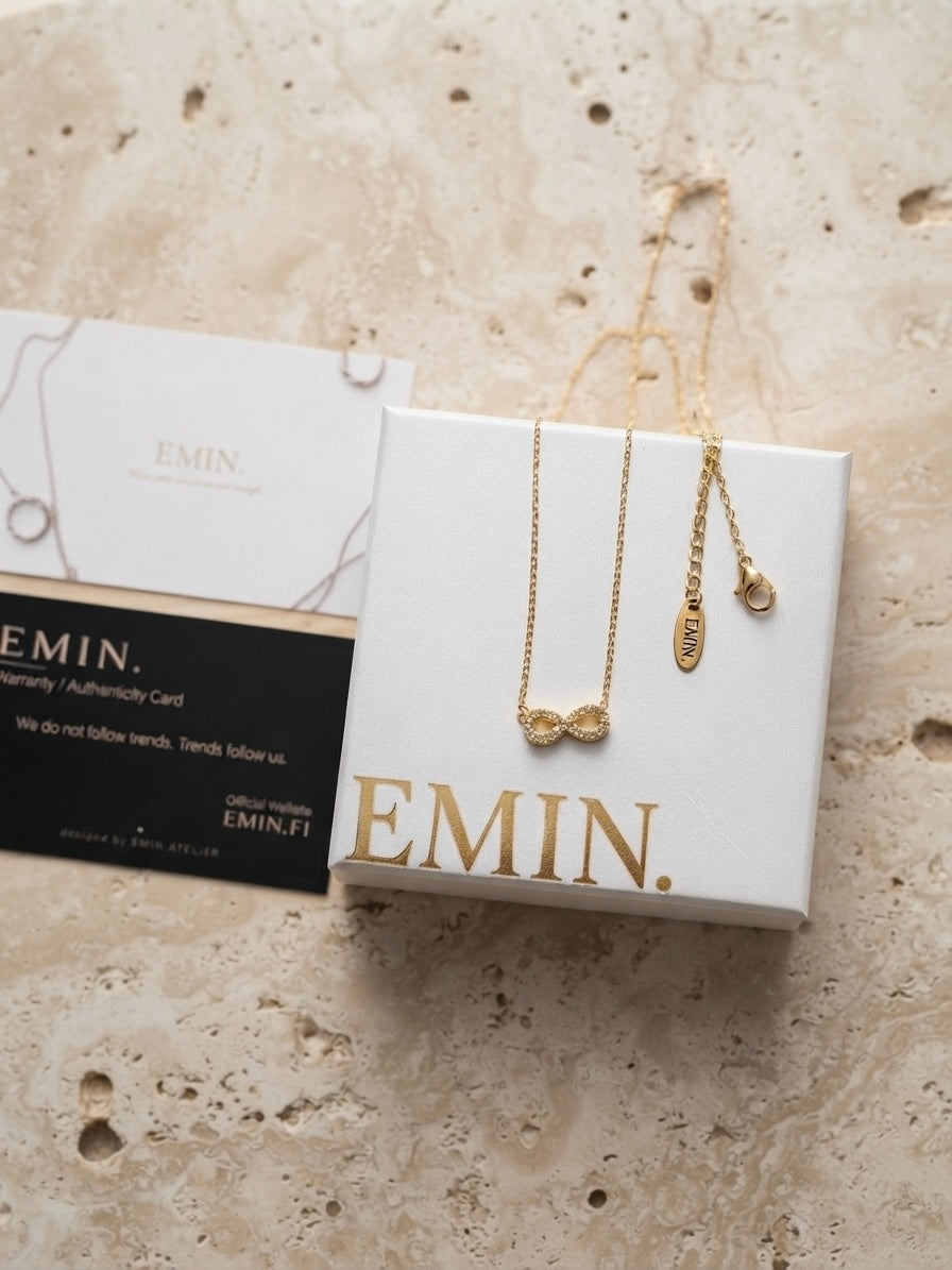 Infinity Necklace Gold – close-up on marble