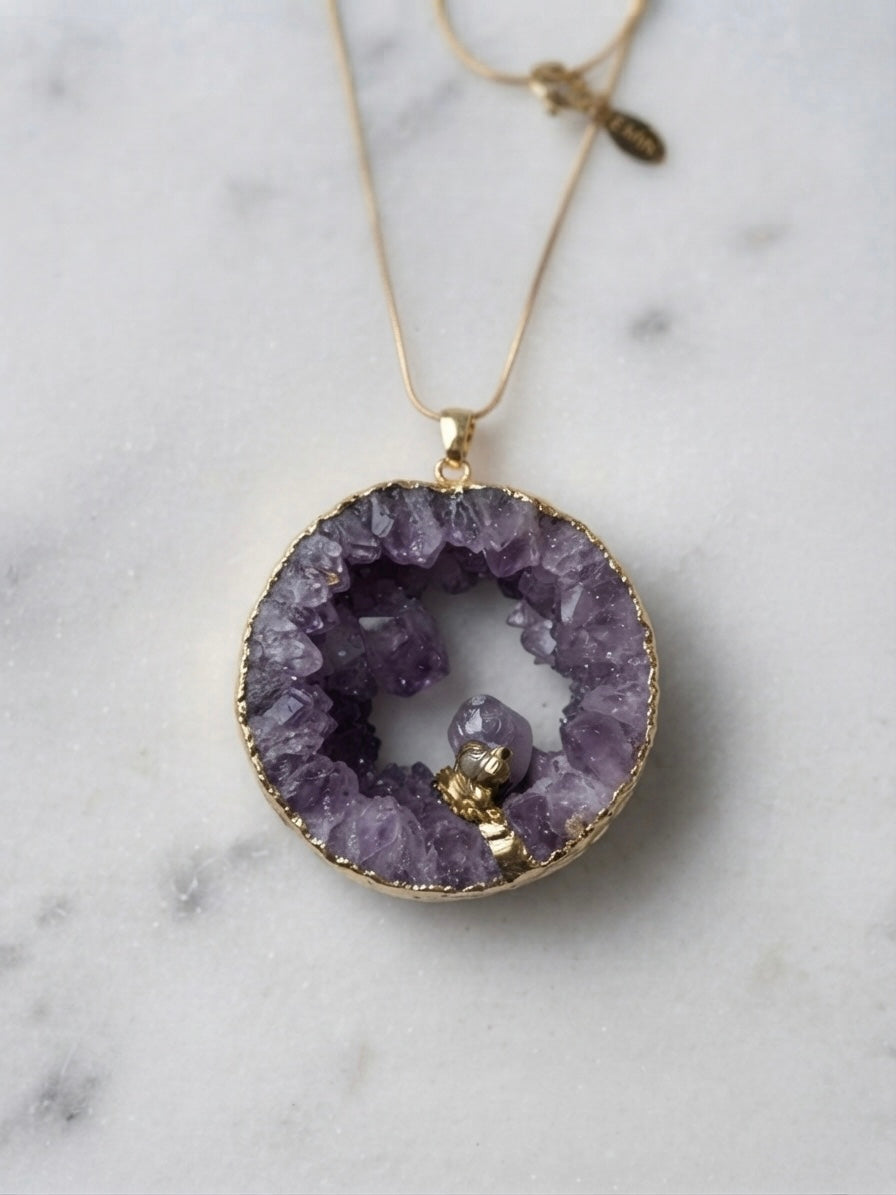 Amethyst geode necklace close-up on marble